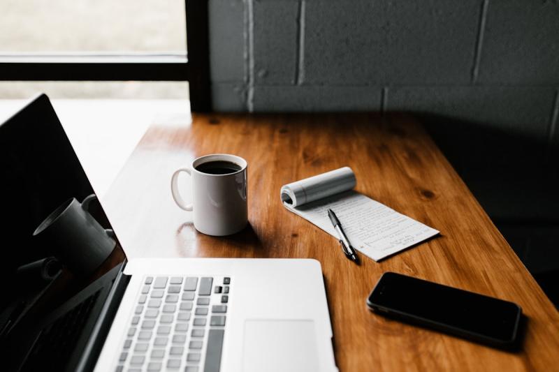 Writer crafting engaging email content at a laptop with coffee